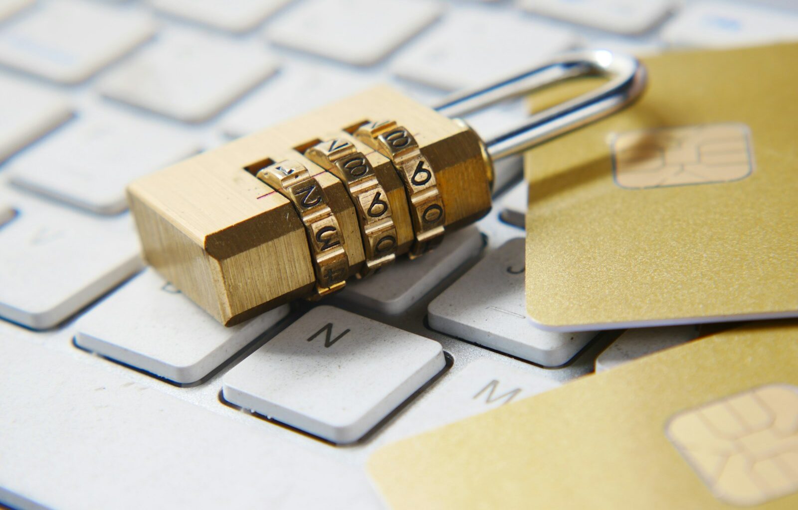 a golden padlock sitting on top of a keyboard